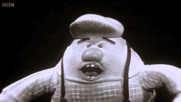 A strange stuffed figure with mouth agape