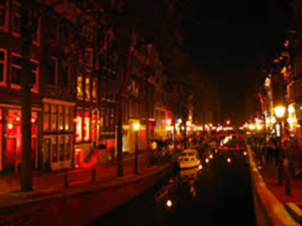 Streetlights line a street in the water, all bathed in crimson.