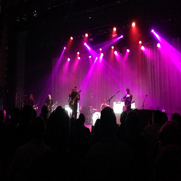 The Afghan Whigs playing live on stage (beneath magenta lights)