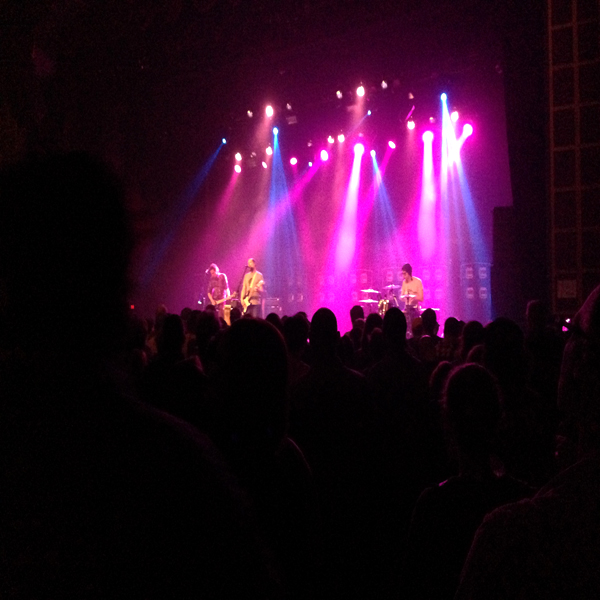 Built To Spill playing live on stage (beneath magenta lights)