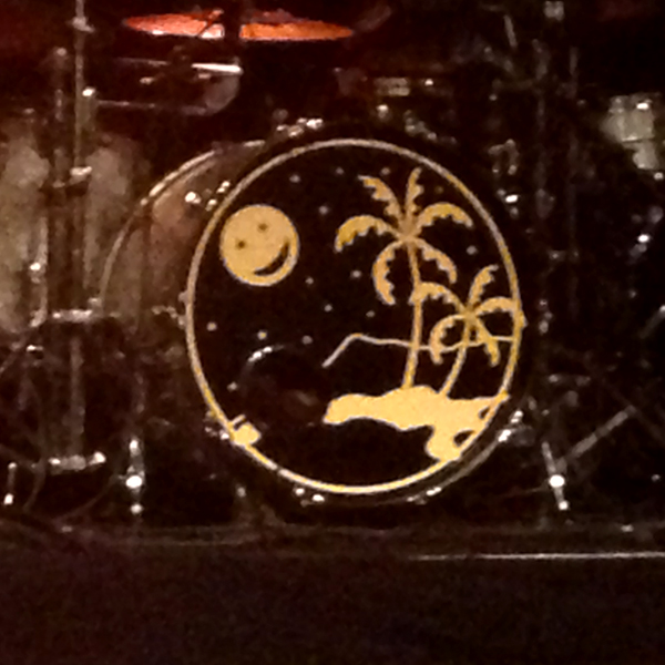 Bass drum with image of a palm tree island and a smiling moon in the starry night sky